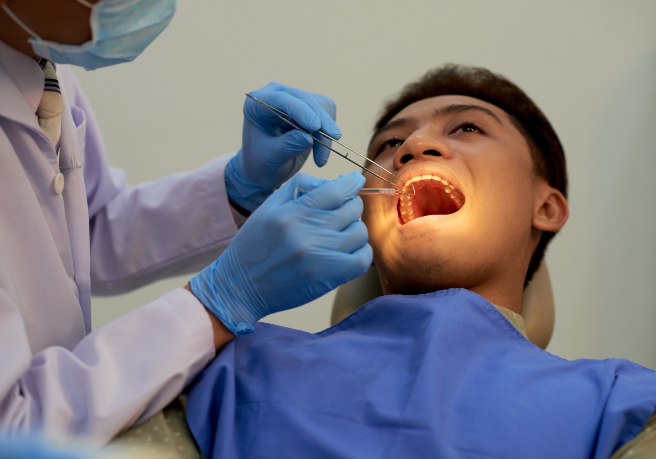 Dental surgeon performing wisdom tooth extraction with advanced equipment in Coimbatore